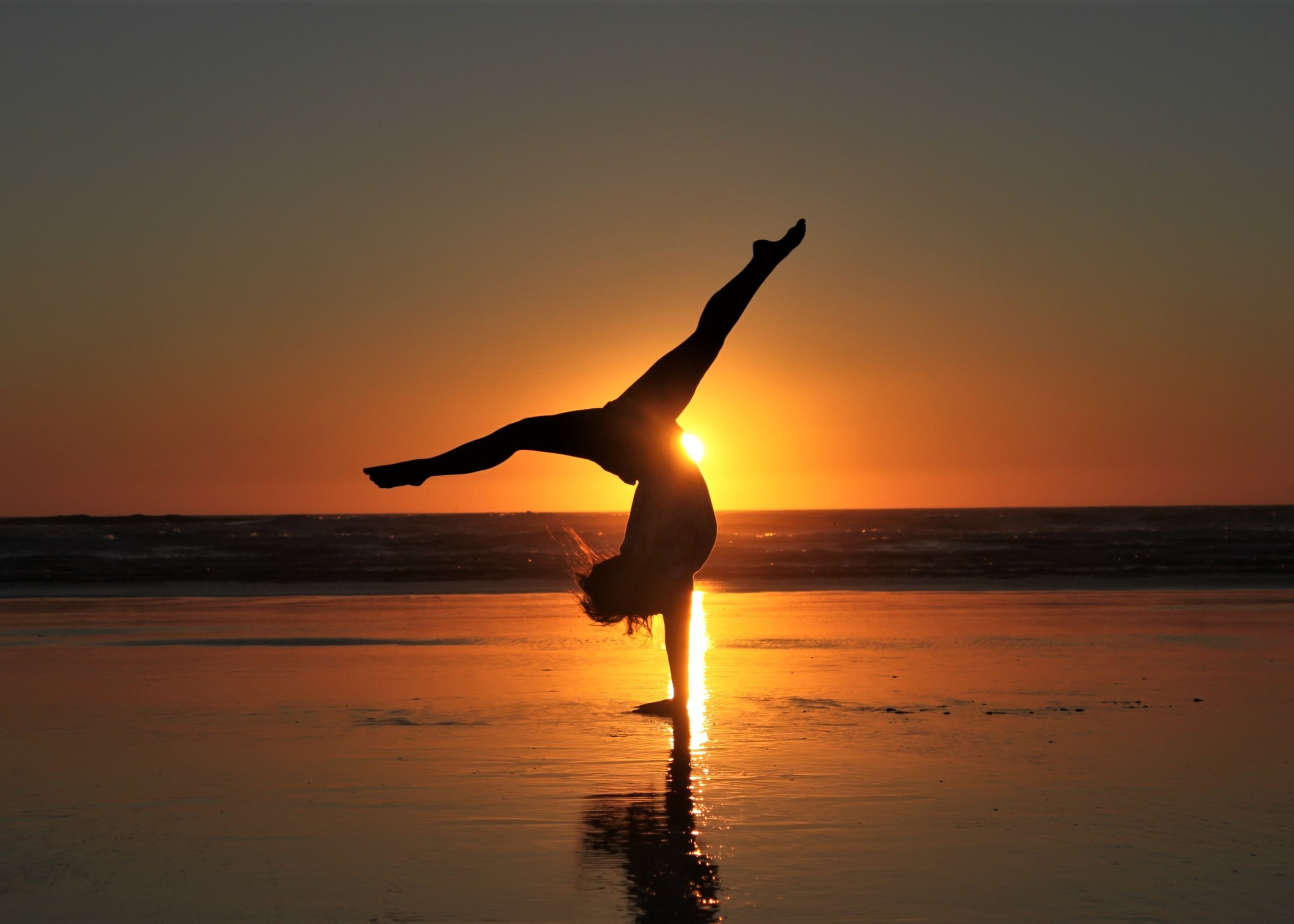 gymnastics on the beach sunset
